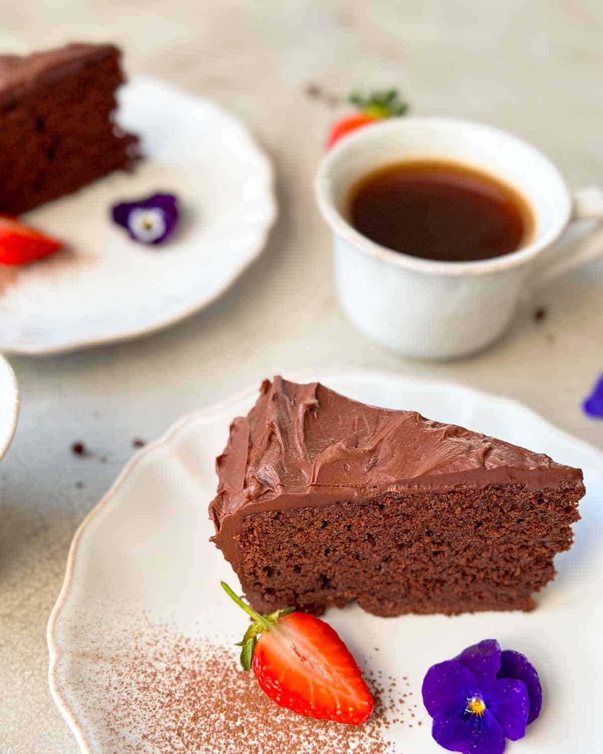A tasty slice of chocolate ganache cake ready to be enjoyed.