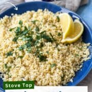 A bowl of perfectly cooked bulgur wheat topped with chopped parsley and lemon wedges, styled for a step-by-step cooking guide with a clean and bright kitchen setup.