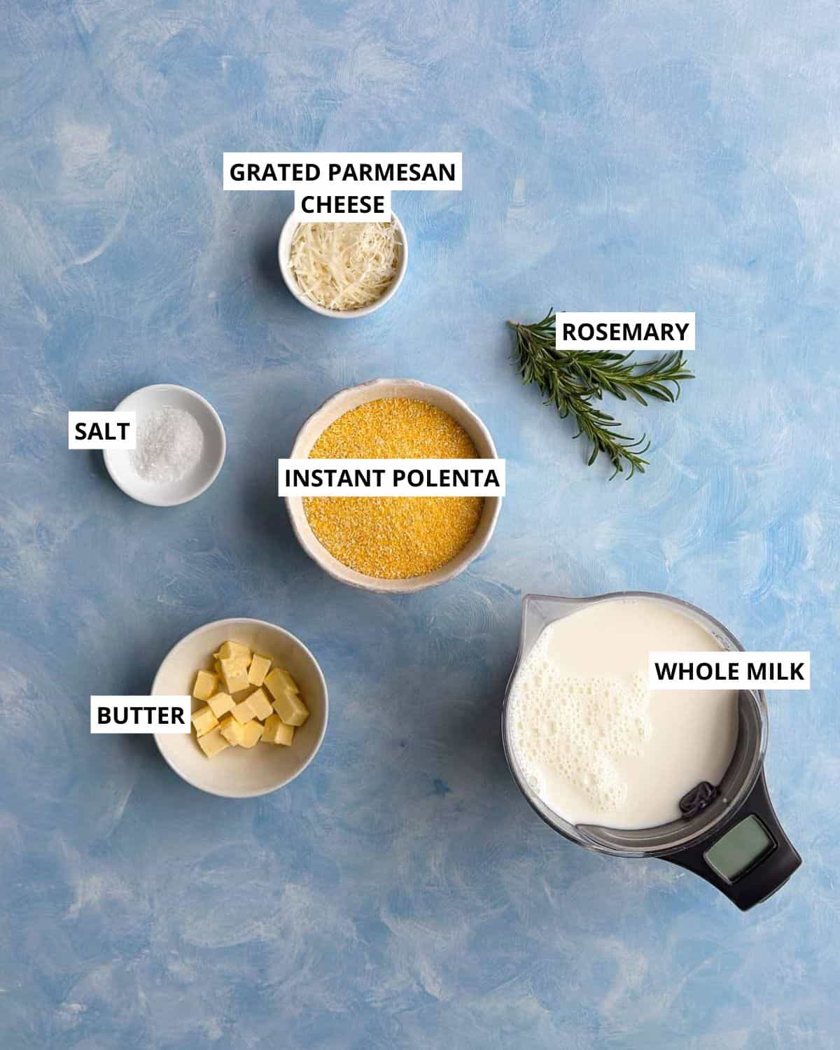 Ingredients for creamy parmesan polenta, including instant polenta, whole milk, butter, parmesan, rosemary, and salt.