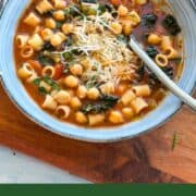 Bowl of Italian chickpea soup (Pasta e Ceci) with ditalini pasta, chickpeas, kale, and grated Parmesan in tomato broth — cozy Mediterranean comfort food perfect for fall or winter dinners.