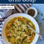 Close-up of lemon chicken orzo soup in a white bowl with a spoon. A comforting rotisserie chicken soup with fresh vegetables, orzo pasta, and lemon for a bright, nourishing dinner that’s perfect for busy weeknights.
