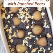 Baked chocolate self-saucing pudding topped with poached pear halves and sliced almonds in a white baking dish. Moist chocolate cake with a hidden sauce layer, perfect for a comforting winter dessert.