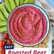 Vegetarian beet hummus dip with roasted beets, served with crunchy cucumber slices and cherry tomatoes.