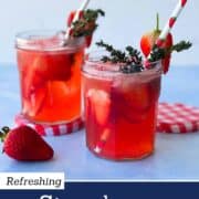 Refreshing strawberry gin cocktail made with strawberry jam and tonic water, served over ice in glass jars and garnished with fresh strawberries and thyme, styled as an easy summer gin cocktail.
