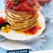 Fluffy yogurt pancakes topped with fresh strawberries and syrup, perfect for breakfast or brunch.