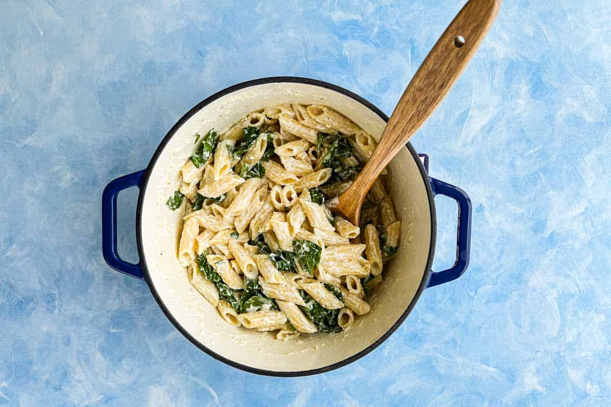 Ricotta and lemon pasta fully mixed with wilted spinach, creating a creamy, fresh, and vibrant pasta dish ready to serve.