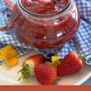 Fresh strawberry compote in a jar with a spoon, perfect for pancakes and desserts.