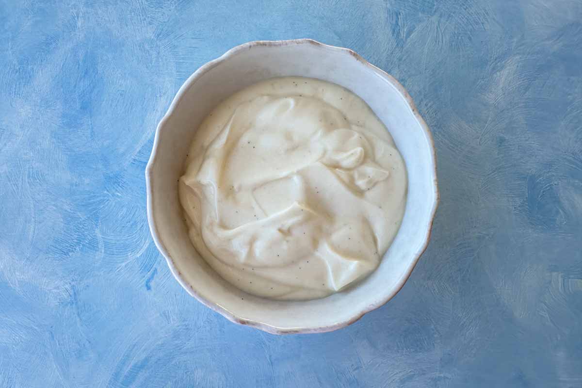 Creamy Greek yogurt mixed with vanilla and honey in a bowl, creating a smooth and lightly sweet base for the parfait.