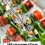 Delicious watermelon and feta skewers with basil and balsamic glaze for summer appetizers.