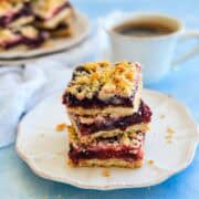 Close-up of homemade berry crumble bars layered with sweet-tart berries and a crisp buttery crumble topping.