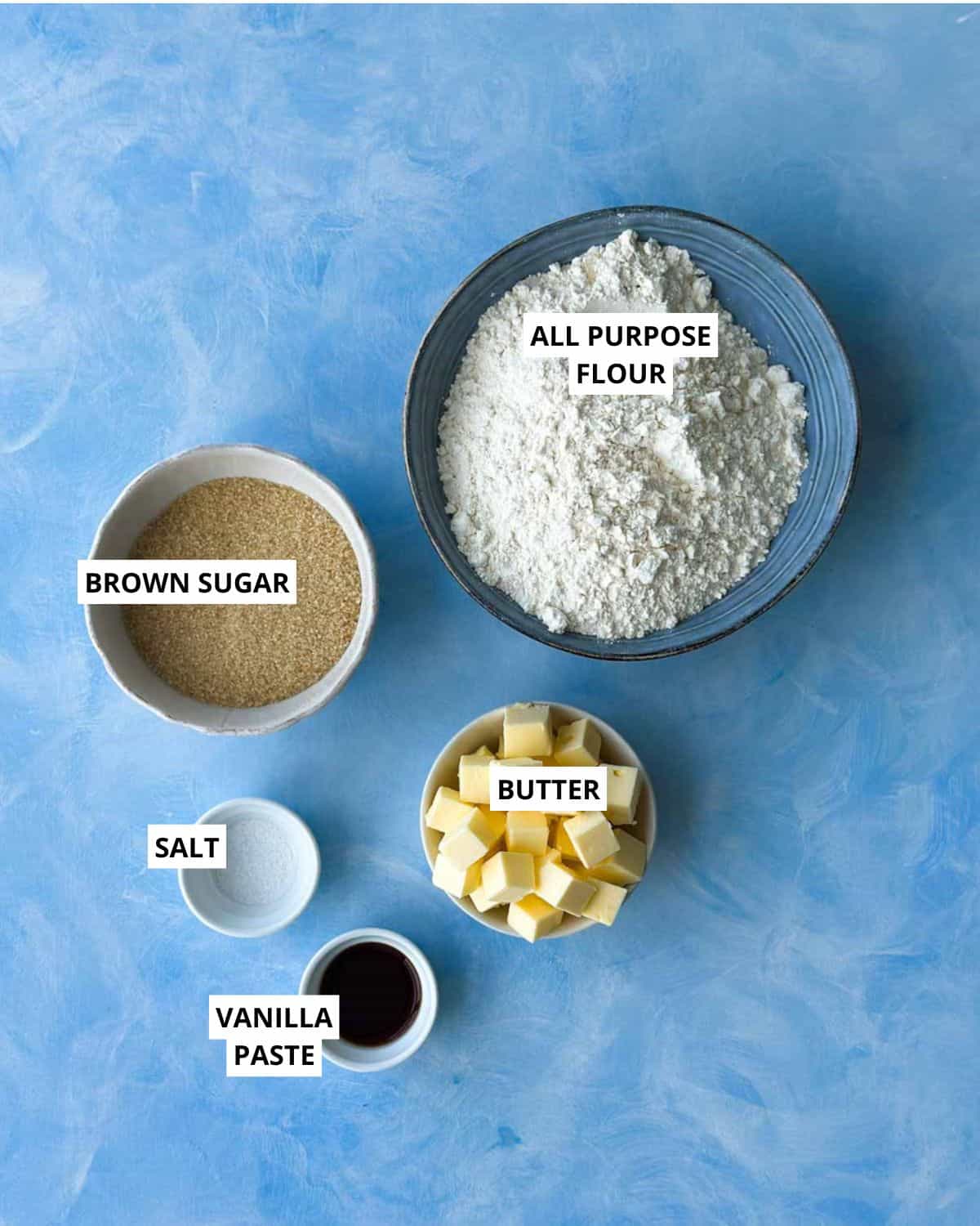 Ingredients for berry crumble bars including all-purpose flour, brown sugar, butter, vanilla paste, and salt.