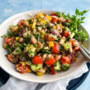Italian bean salad with cannellini beans, butter beans, olives, and crisp vegetables tossed in Italian dressing.