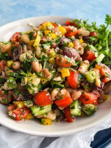 Italian bean salad with cannellini beans, butter beans, olives, and crisp vegetables tossed in Italian dressing.