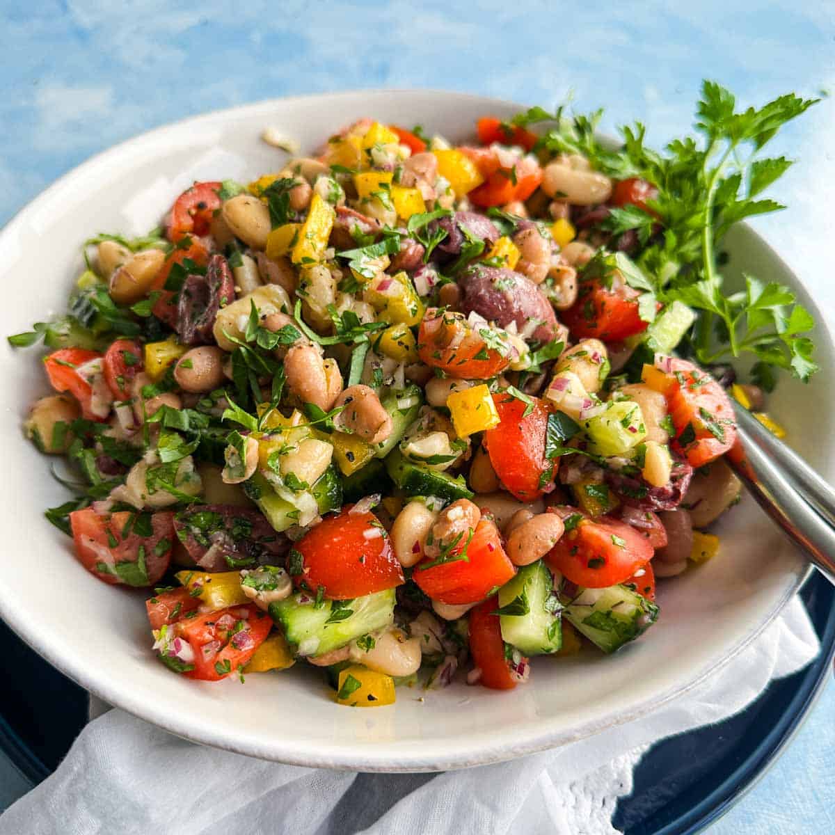 Italian bean salad with cannellini beans, butter beans, olives, and crisp vegetables tossed in Italian dressing.