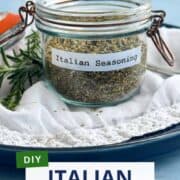Italian seasoning mix in glass jar with herbs, perfect for cooking and gifting.