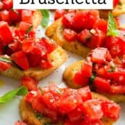 Close-up of tomato bruschetta on toasted bread with basil, perfect for summer appetizers.