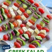 Greek salad skewers with cherry tomatoes, cucumber, feta cheese, and olives on wooden picks. Perfect.
