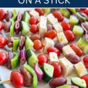 Colorful Greek salad skewers with cherry tomatoes, cucumbers, feta cheese, and olives.