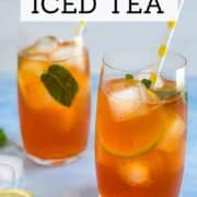 Refreshing lemon iced tea with ice, lemon slices, and mint leaves.