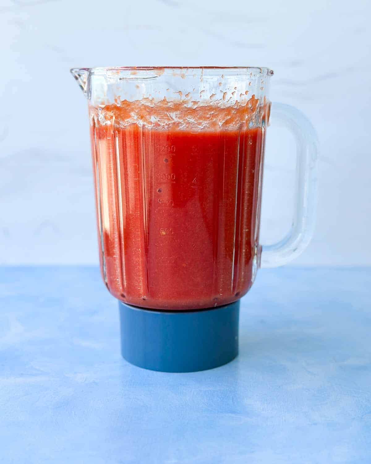 Canned whole peeled tomatoes blended into a smooth red sauce for spicy tomato pasta sauce.
