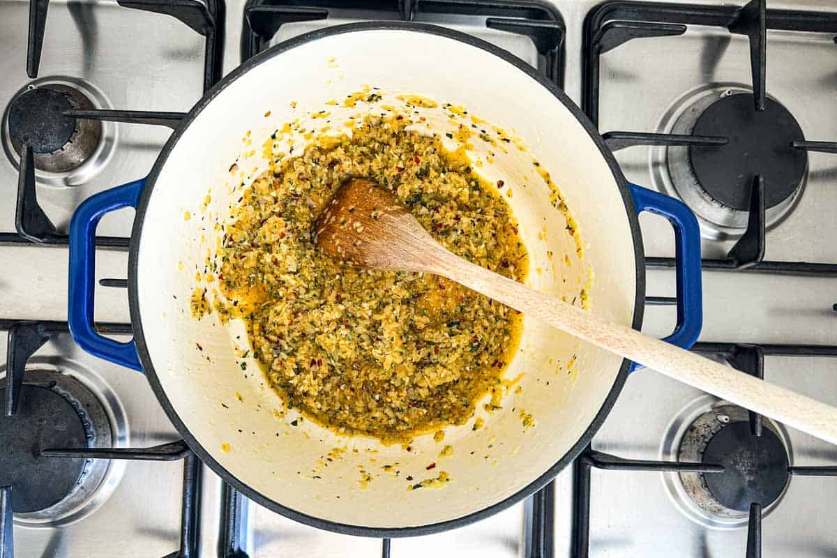Onion, garlic, chili flakes, and herbs cooked down in olive oil for the spicy tomato sauce base.