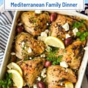 Baked Greek lemon chicken and potatoes with herbs and garnishes.