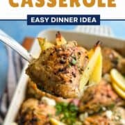 Delicious Greek chicken and potatoes casserole with herbs and lemon slices.