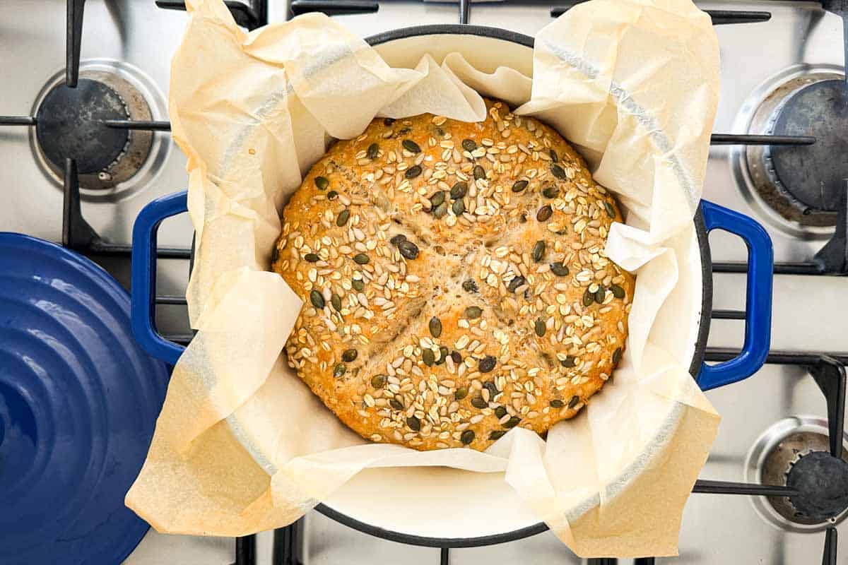 Freshly baked no-knead bread in the parchment-lined Dutch oven.