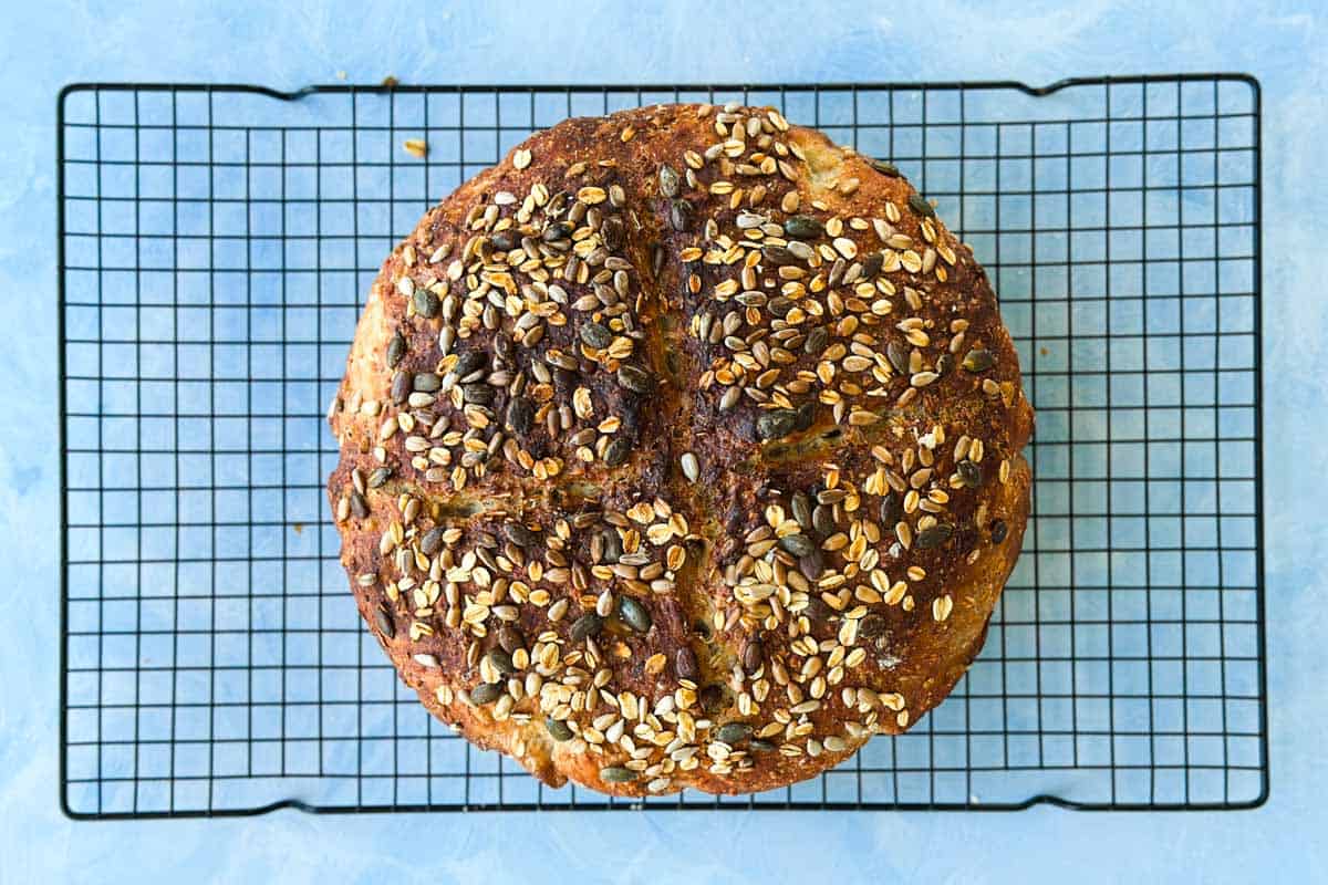 Baked no-knead loaf cooling on a wire rack.