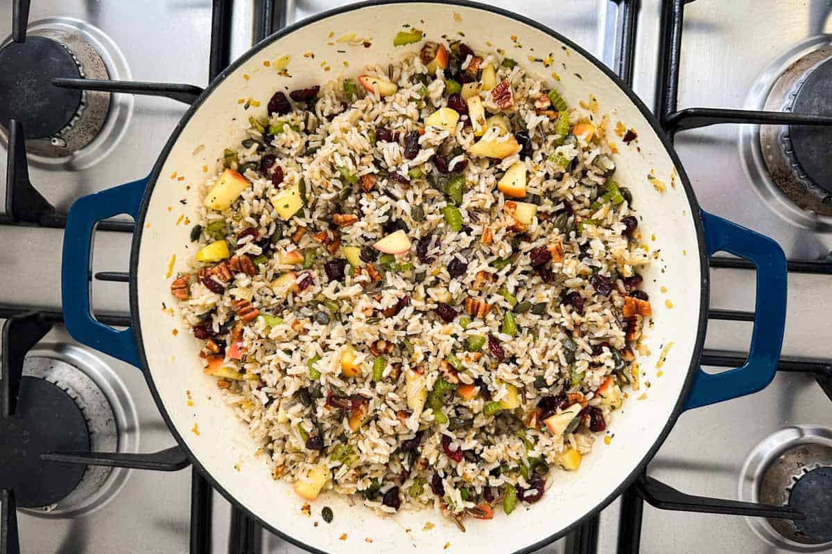 The cooked rice stirred into the apple, cranberry, and pecan mixture to finish the pilaf.